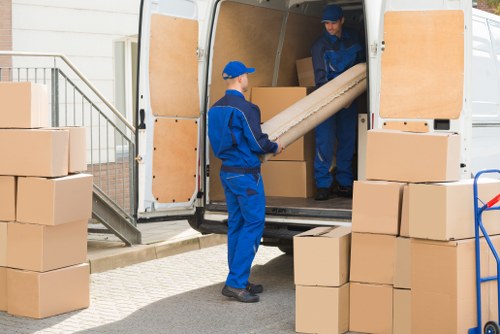 Removal team preparing moving equipment with safety focus